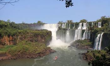 a large waterfall over a body of water