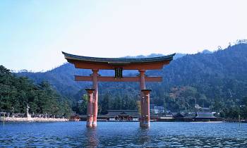 a large body of water with a mountain in the background
