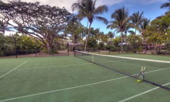 a person with a racket on a tennis court holding a racquet