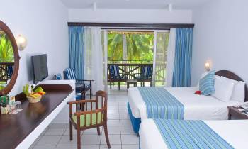 a bedroom with a bed and a chair in a room