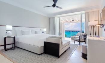 a bedroom with a bed and desk in a room