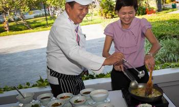 a man standing in front of a cake
