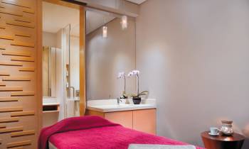 a bedroom with a large red chair in a room