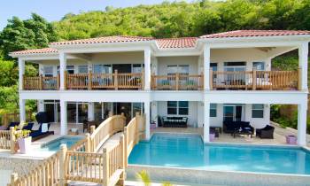 a house with a pool in front of a building