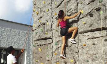 a person standing next to a rock wall