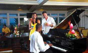 a man standing in front of a piano