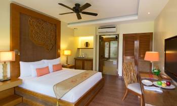 a bedroom with a bed and a table in a room