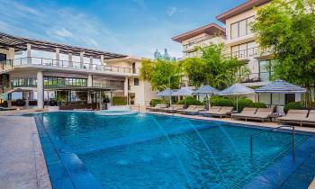 a house with a pool outside of a building