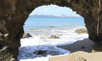a rocky beach next to a body of water