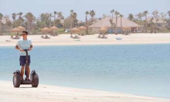 a man riding a motorcycle on a beach