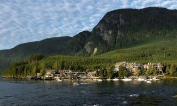 a large body of water with a mountain in the background