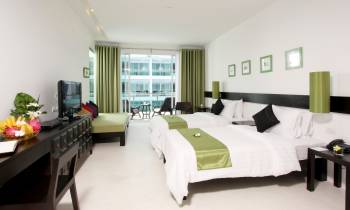 a bedroom with a large bed in a hotel room
