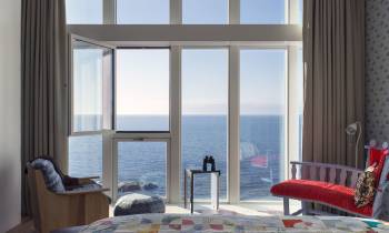 a living room filled with furniture and a large window