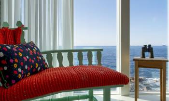 a large red chair in front of a window