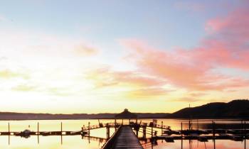 a close up of a pier next to a body of water