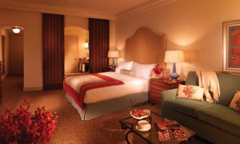 a hotel room with a red rug