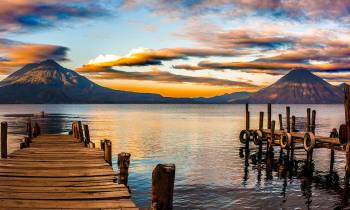 a wooden pier next to a body of water