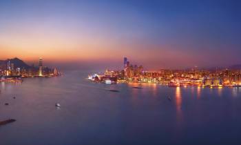 a large body of water with a city in the background
