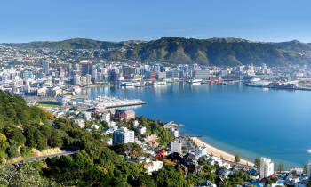 a large body of water with a city in the background