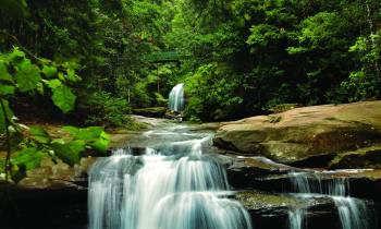 a large waterfall over some water