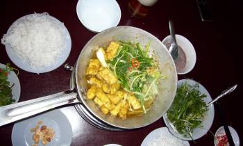 a bowl of food on a plate on a table