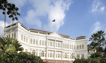 a car parked in front of Raffles Hotel
