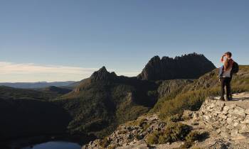 a man standing on a rocky hill