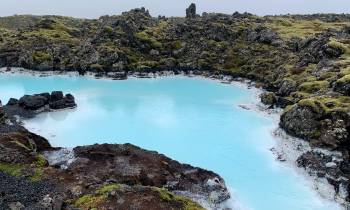 A beautiful blue lagoon surrounded by green covers