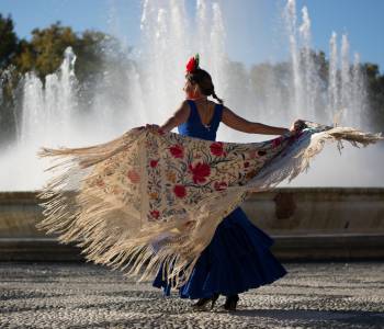 Beautiful woman dancing flamenco near the fountain