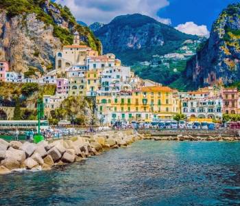 Enchanting Travels Italy Tours Wonderful Italy. The small haven of Amalfi village with a turquoise sea and colorful houses on the slopes of the coast