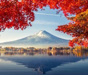 Enchanting Travels Japan Tours Colorful Autumn Season and Mountain Fuji with morning fog and red leaves at lake Kawaguchiko is one of the best places in Japan