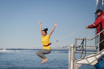 A passenger takes the Polar Plunge in Arctic Waters