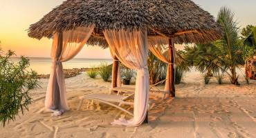 Is Zanzibar safe? Beach lounge chairs at sunset at the shore of Indian ocean, Zanzibar, Tanzania, Africa Enchanting Travels