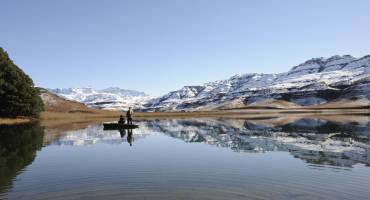 flyfishing for trout against a backdrop of snow at giants cup wilderness reserve, kwazulu natal, south africa - history of South Africa