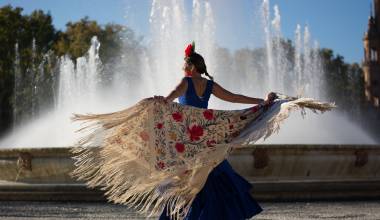 Beautiful woman dancing flamenco near the fountain