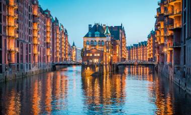 Classic view of famous Speicherstadt warehouse district, a UNESCO World Heritage Site since 2015, illuminated in beautiful post sunset twilight at dusk, Hamburg, Germany