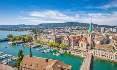 Aerial view of historic Zurich city center with famous Fraumunster Church and river Limmat at Lake Zurich from Grossmunster Church on a sunny day with clouds in summer, Canton of Zurich, Switzerland