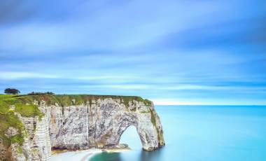 Etretat, la Manneporte natural rock arch wonder, cliff and beach. Long exposure photography. Normandy, France, Europe