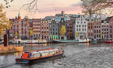 Channel in Amsterdam Netherlands houses river Amstel landmark old european city spring landscape.