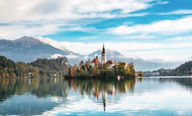 Church of Assumption in Lake Bled, Slovenia with blue sky and clouds in the autumn