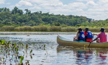 Enchanting Travels Brazil Tours Tourists with a guide in a canoe at Pantanal Marimbus (Marshland Marimbus), Chapada Diamantina, Bahia, Brazil