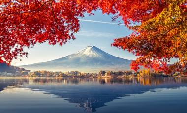 Enchanting Travels Japan Tours Colorful Autumn Season and Mountain Fuji with morning fog and red leaves at lake Kawaguchiko is one of the best places in Japan
