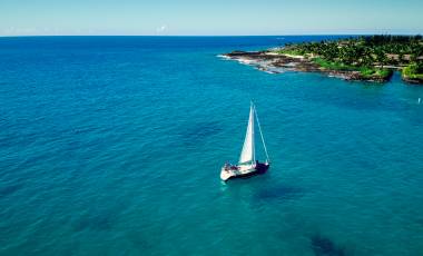 Sailboat sailing in ocean in Hawaii.