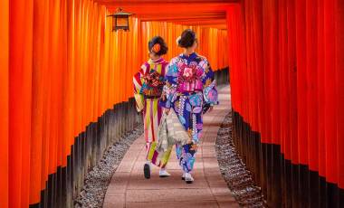 Top 10 temples in Japan - Women in traditional japanese kimonos walking at Fushimi Inari Shrine in Kyoto, Japan
