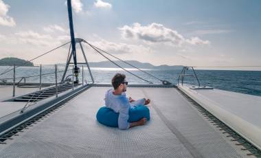 happy holiday Luxury Travel by Catamaran in the Ocean by the Seychelles island, Young man at sailing boat