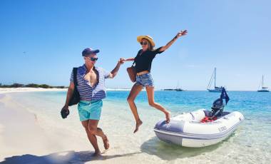 Couple beaching a dinghy