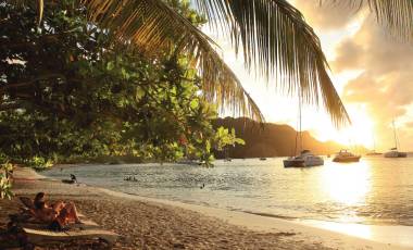 Caribbean beach with boats anchored offshore