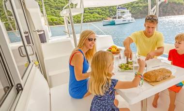 Family eating aboard a catamaran