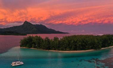 Dramatic Tahiti sunset with Catamaran