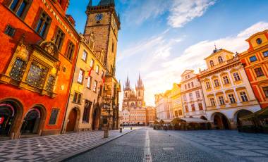 View of the town Hall and Temple of Our Lady before Tyn in sunlight at dawn Prague Czech Republic